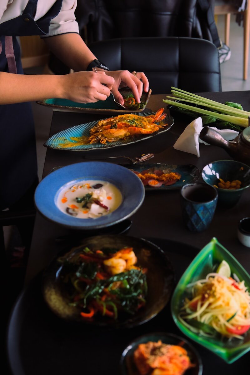 a table topped with plates and bowls of food