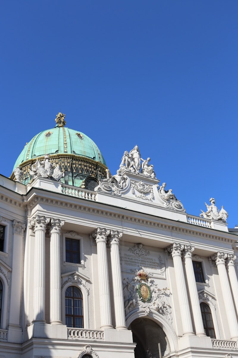 A large white building with a green dome on top